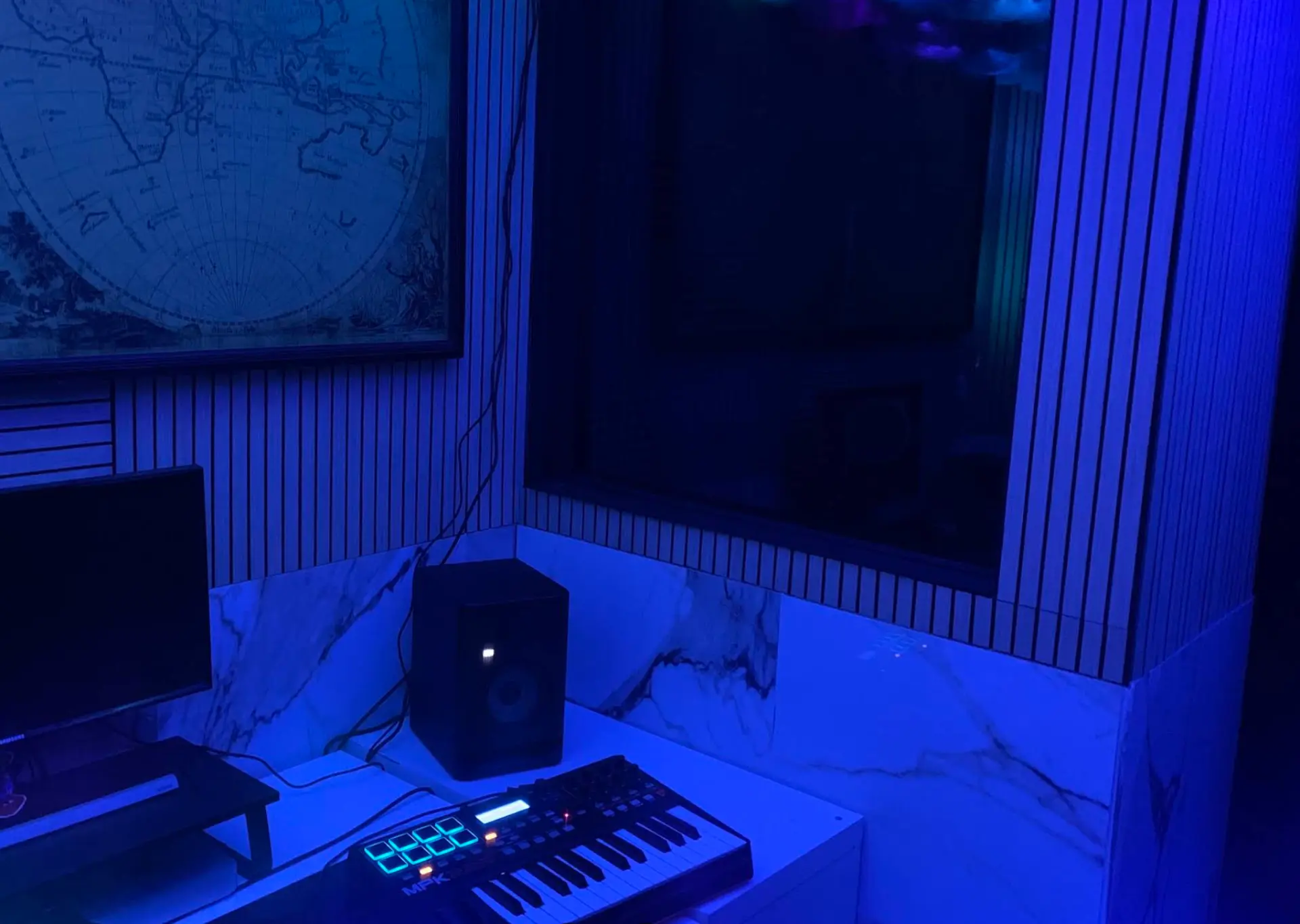 Control Room A — blue LED-lit production desk with studio monitors